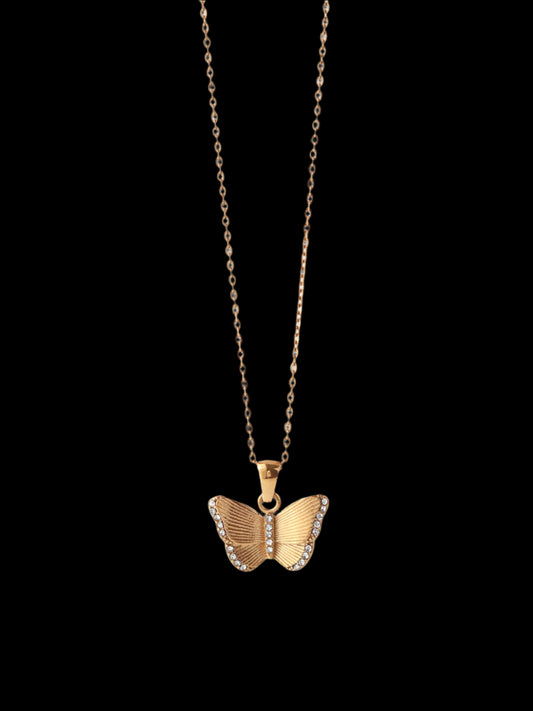Gold butterfly necklace on a white background