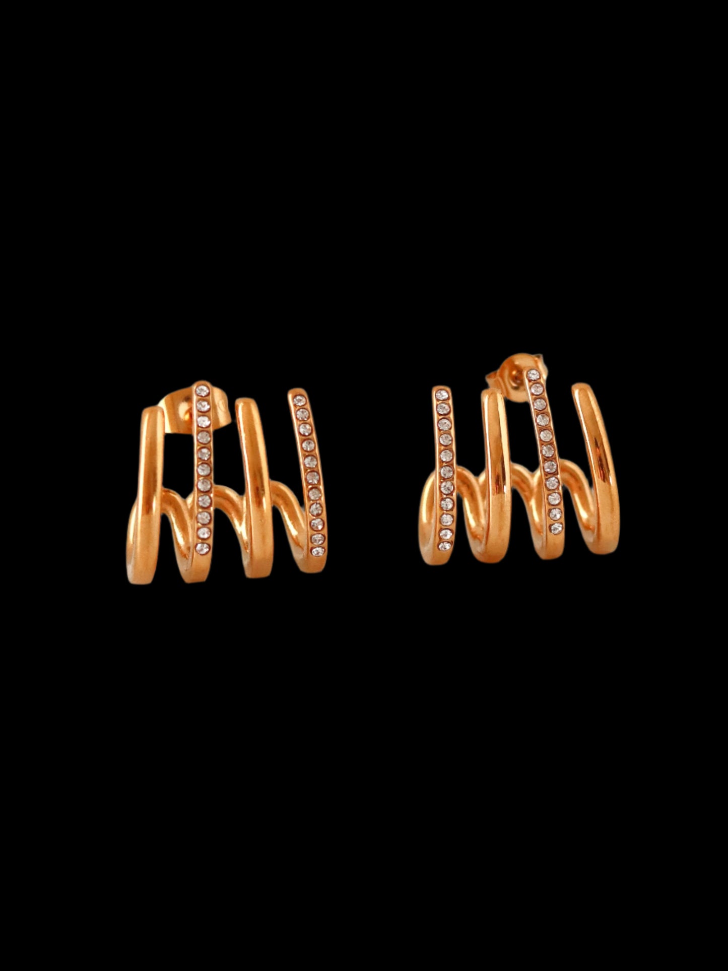 Pair of gold hoop earrings with small diamonds on a light gray background