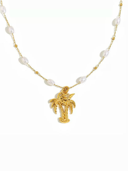 A gold chain necklace featuring irregular white pearl-like beads and a small gold palm tree pendant, displayed on a clean white background.