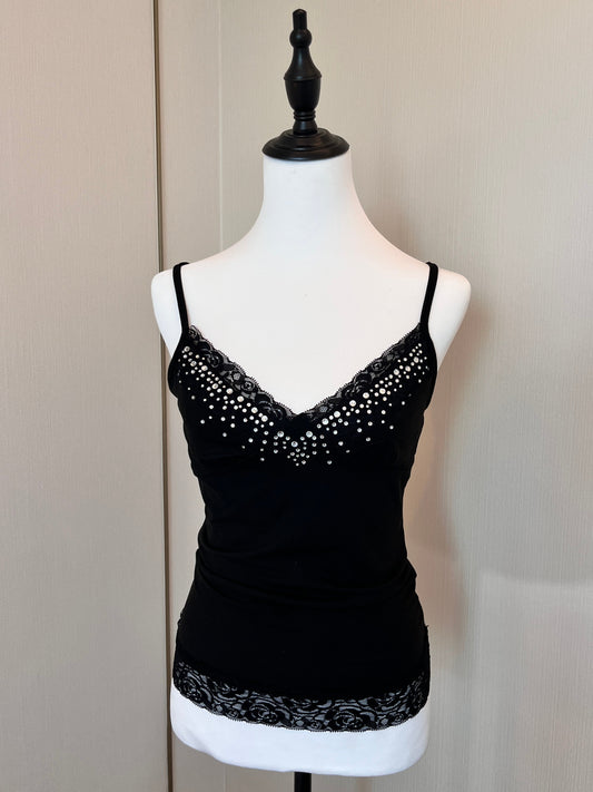 Black sequin dress on a mannequin against a plain background