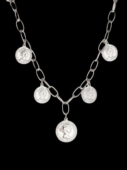 Silver chain necklace with round pendants on a light gray background