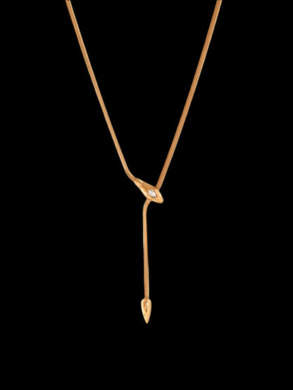 Gold necklace with a unique pendant on a white background