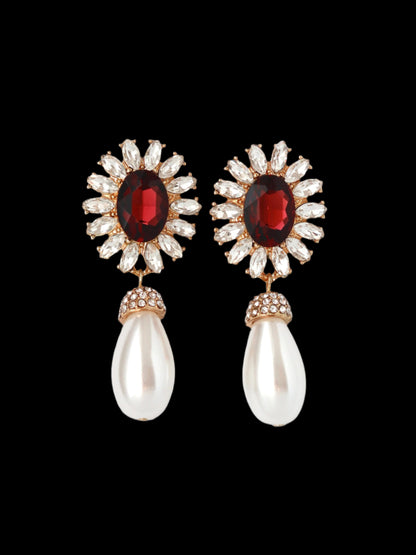 Pair of earrings with gemstones and pearls on a white background