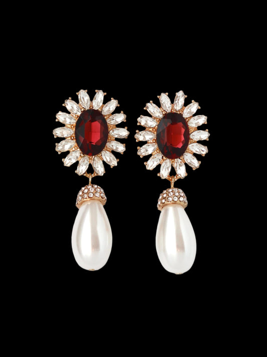 Pair of earrings with gemstones and pearls on a white background