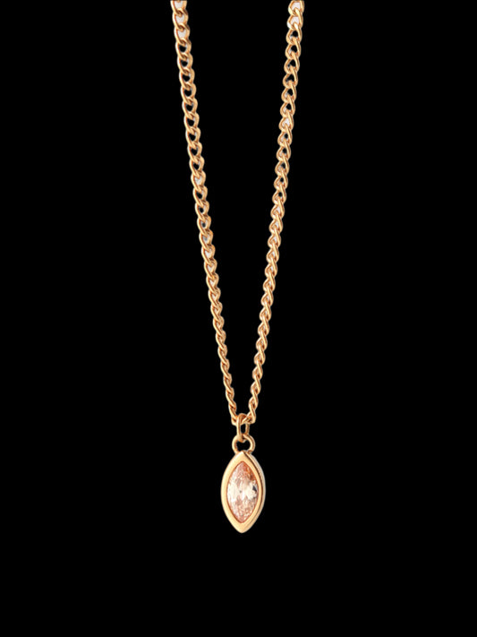 Gold necklace with a marquise-shaped pendant on a light gray background