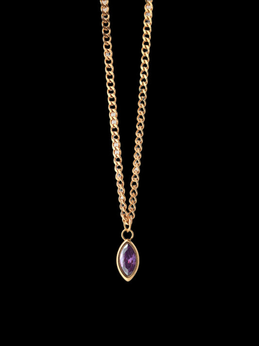 Gold necklace with a purple gemstone pendant on a white background