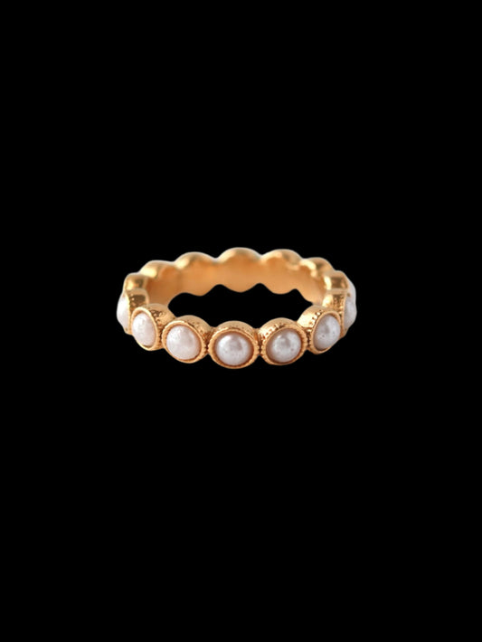 Gold ring with small pearls on a white background