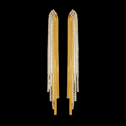 Gold tassel earrings on a white background